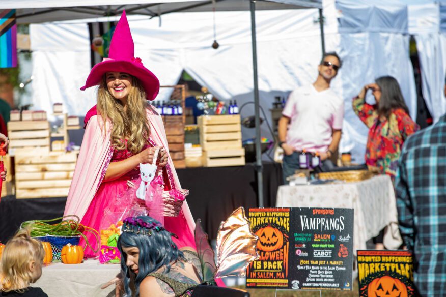 Witch in Pink on Salem Common with vendors in the background