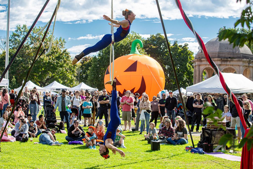 Two aerial performers entertain visitors at the Haunted Happenings Marketplace on Salem Common.