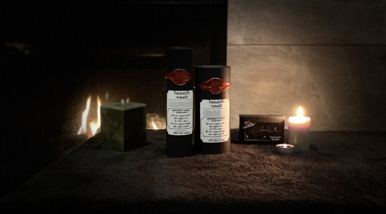 Ash △ Ember Hearth Hearth Ward candles and black wax-sealed packaging displayed beside a fireplace.