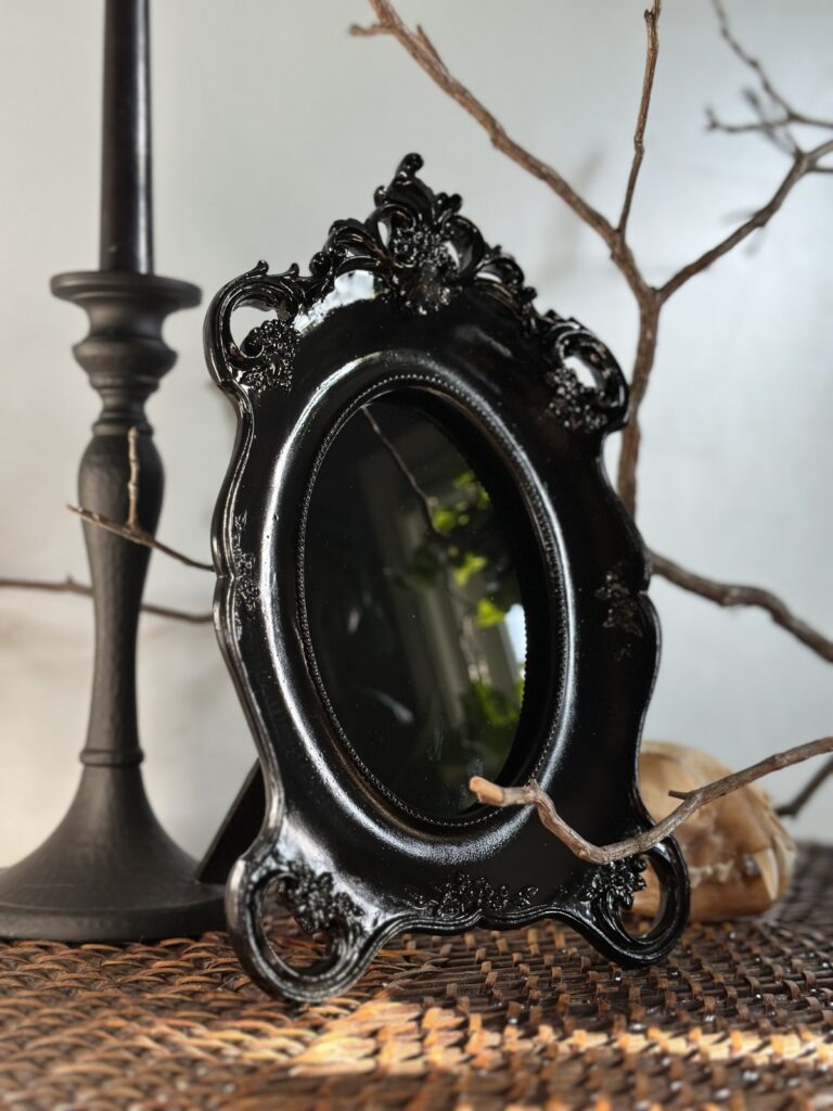 Black ornate scrying mirror handmade by Botanical Bones Shoppe