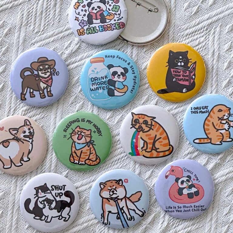 Illustrated cat and panda pin buttons by Envision Creative LLC