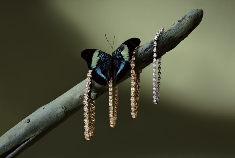 Jenni Stuart Fine Jewelry — diamond tennis bracelets on a branch beside a blue-and-black butterfly