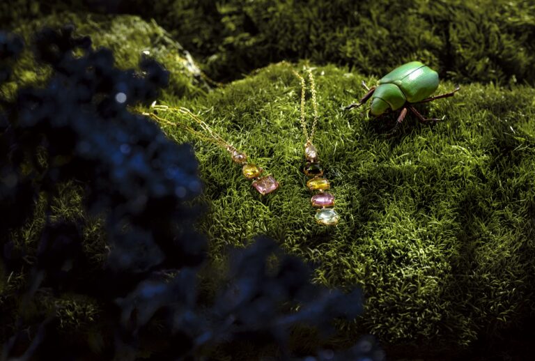 Jenni Stuart Fine Jewelry — colorful tourmaline necklaces on moss beside a green beetle