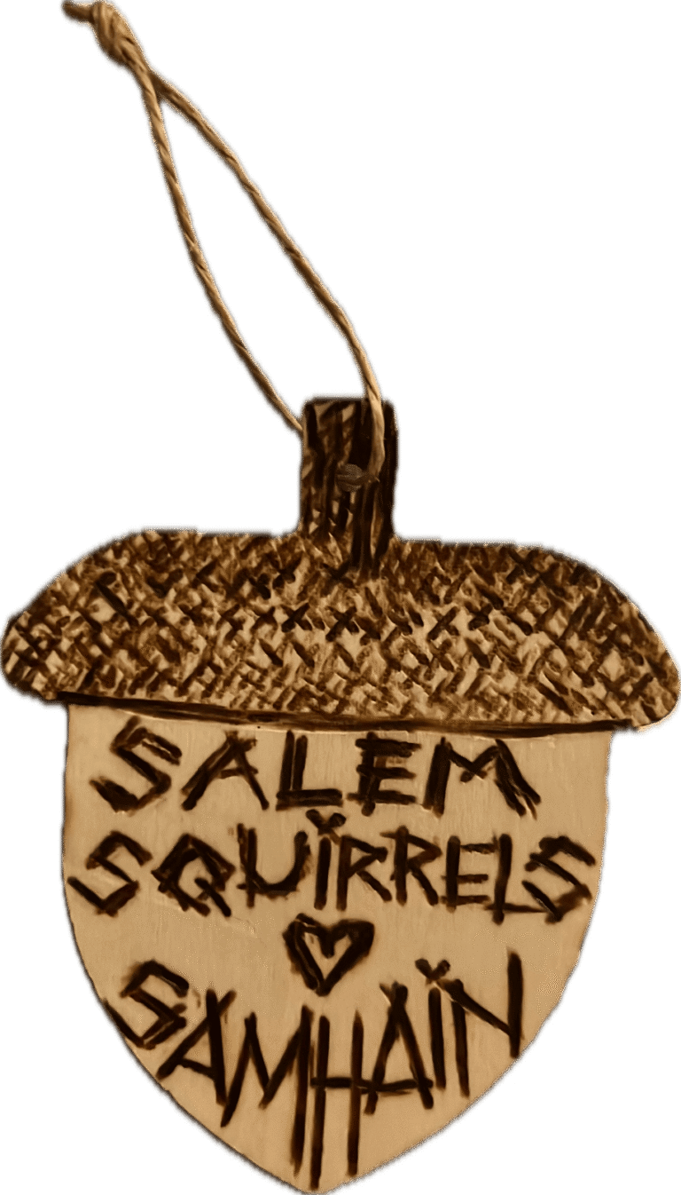 An acorn-shaped handmade ornament reading Salem Squirrels with a heart and GWAAN