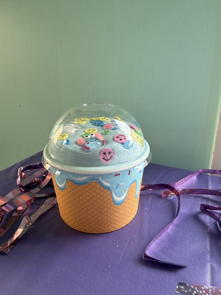 Blue slime with smiley charms in an ice cream cup