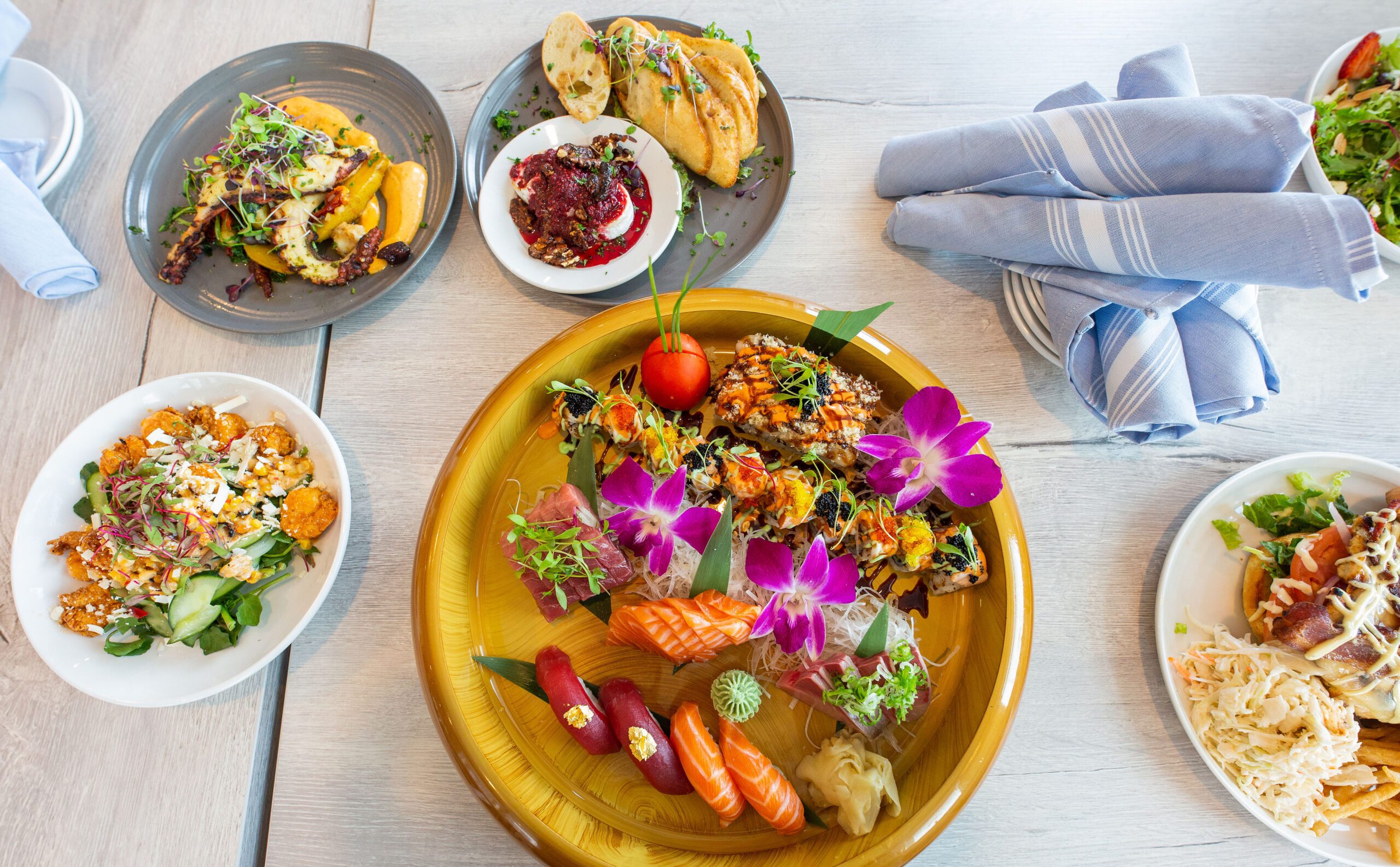 Sushi, sashimi and seafood dishes arranged on a table at Finz Seafood and Grill in Salem.