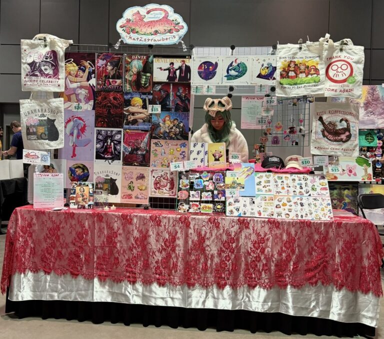 KATERI ART SHOP booth with prints tote bags and keychains